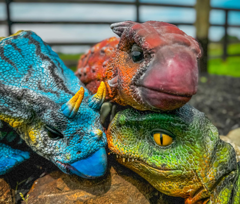 three dinosaur puppets