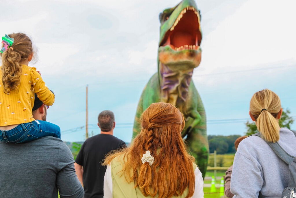 Visitors watch the 6-meter-tall green animatronic Tyrannosaurus Rex roar at the Jurassic Farm