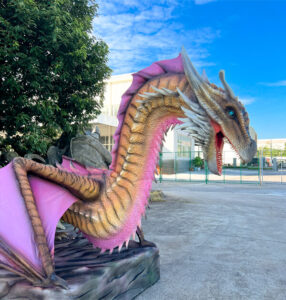 pink and yellow skin animatronic dragon